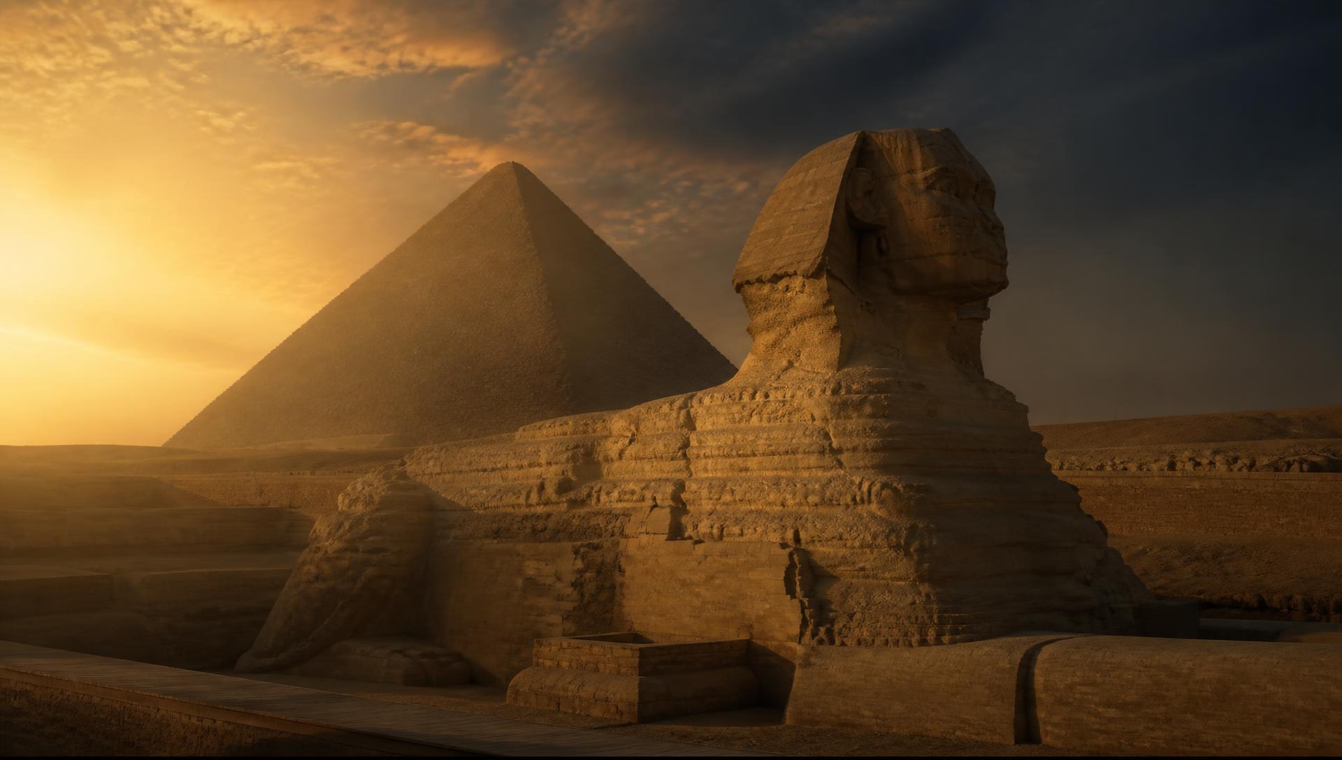 The Great Sphinx of Giza at dawn with the pyramid behind